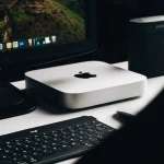 A sleek and modern workspace featuring a desktop computer, keyboard, and speaker.
